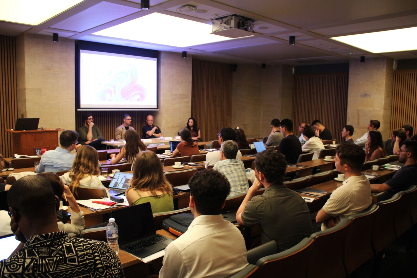 Graduate students and faculty during a conference session